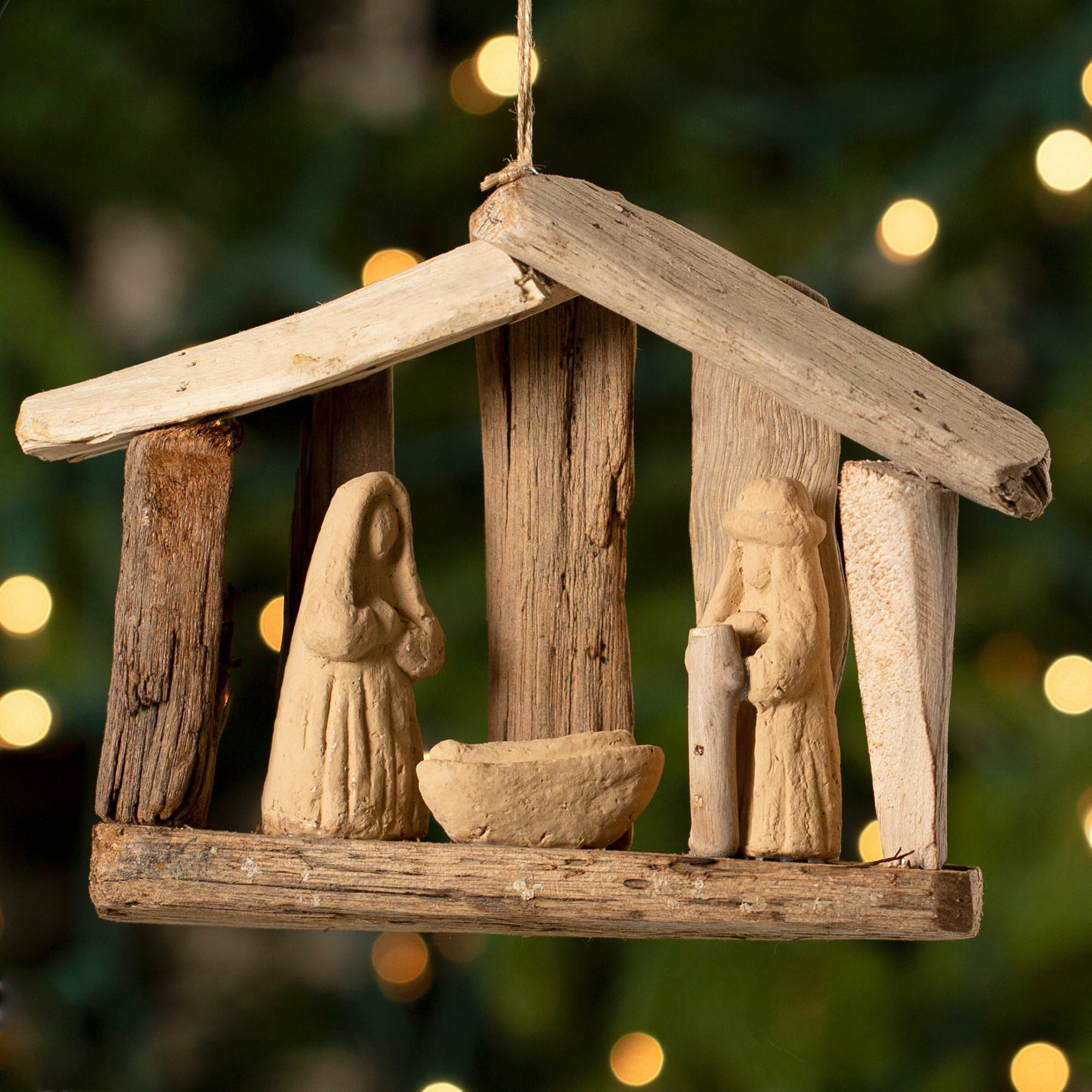 Recycled driftwood and clay nativity ornament with Mary, Joseph, and baby Jesus, handmade and eco-friendly holiday decoration.