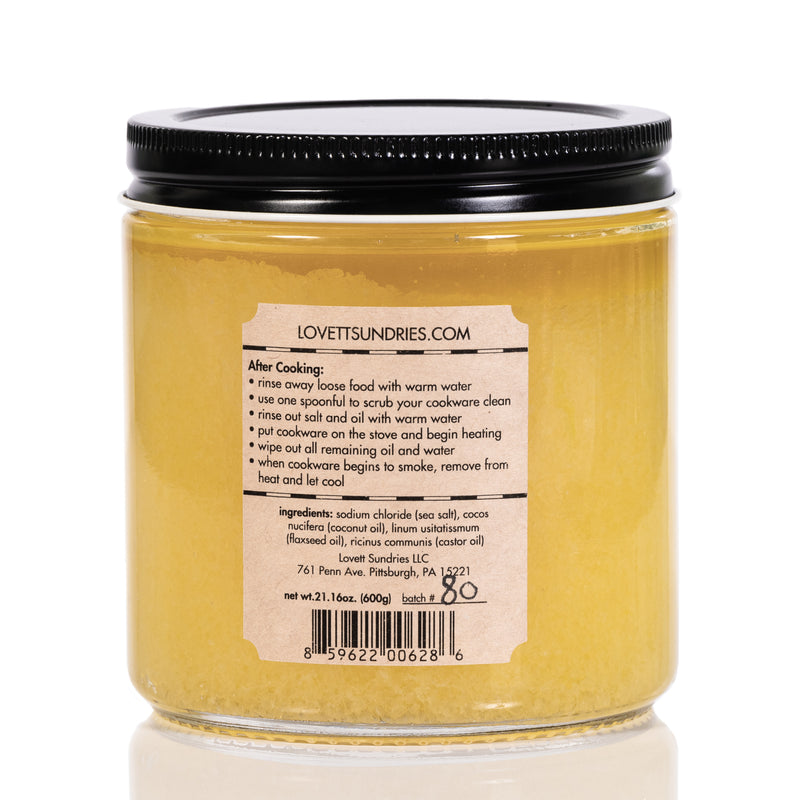 A jar of Cast Iron Conditioner is viewed from the back. The label provides "After Cooking" instructions and lists the ingredients: sodium chloride, cocos nucifera, linum usitatissimum and ricinus communis.