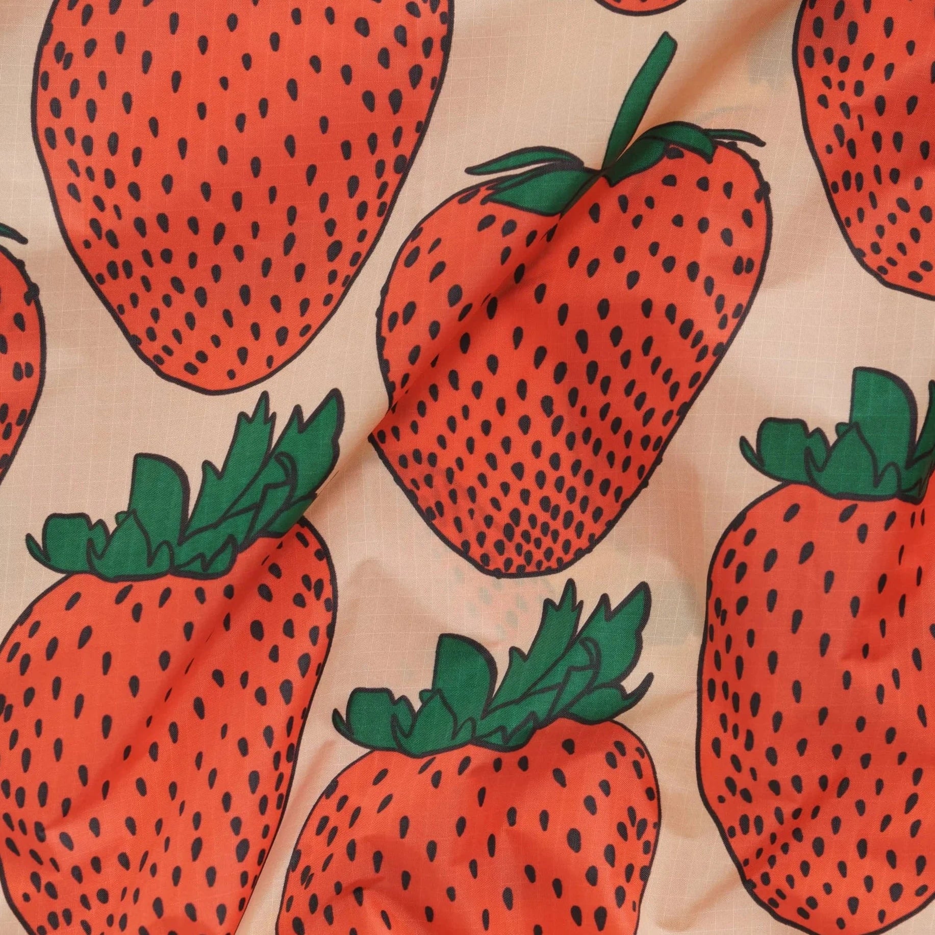 Close up of the print of the BAGGU strawberry reusable bag.