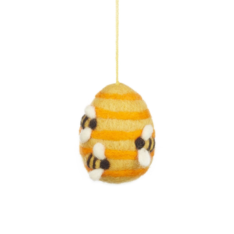 A handmade felt Easter egg decoration is shown, which is yellow with orange stripes and has three small bees on it.