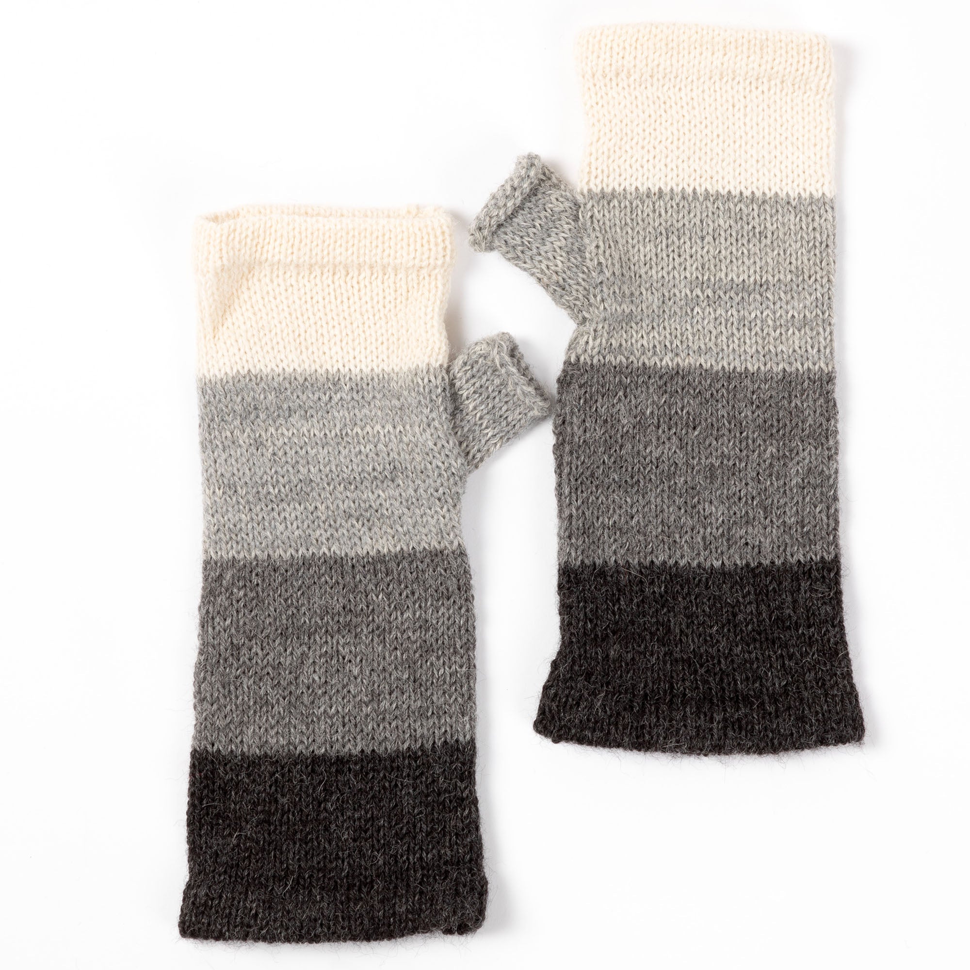 White, gray, and black alpaca fingerless mittens featuring a soft, durable knit. Handmade in Bolivia from 100% alpaca wool.