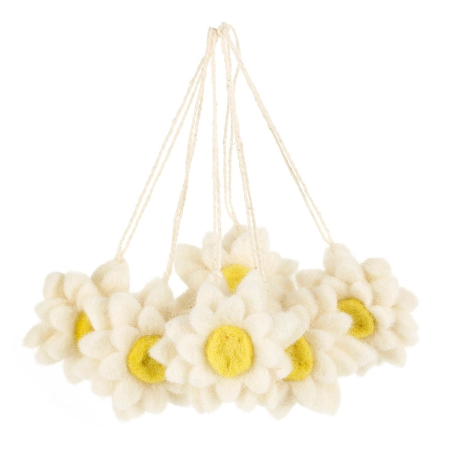 A group of hanging decorations shaped like white daisies with yellow centers are shown.