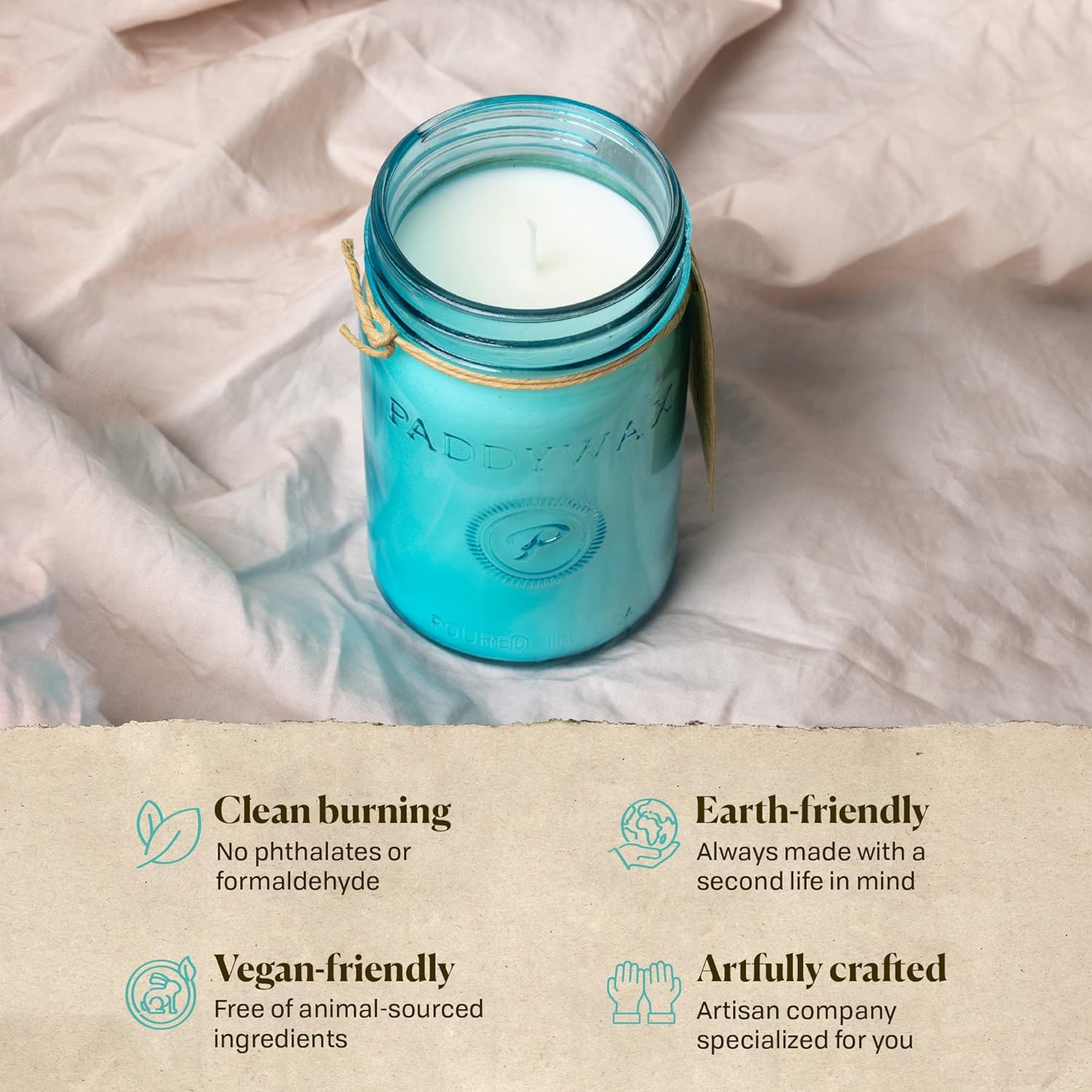 This image shows a blue Paddywax candle in its jar, which has a tag attached. It is resting on a neutral-colored fabric. The image also details several perks of the product.
The candle is:
Clean burning: It is made without phthalates or formaldehyde.
Earth-friendly: The company makes its products with the intention of a second life for the item.
Vegan-friendly: The candle is free of animal-sourced ingredients.
Artfully crafted: It is a product from an artisan company.