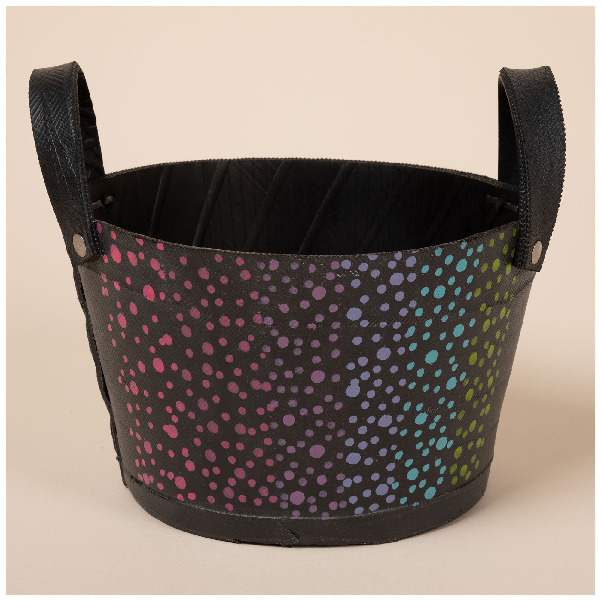 A black storage bin with a colorful dotted pattern.