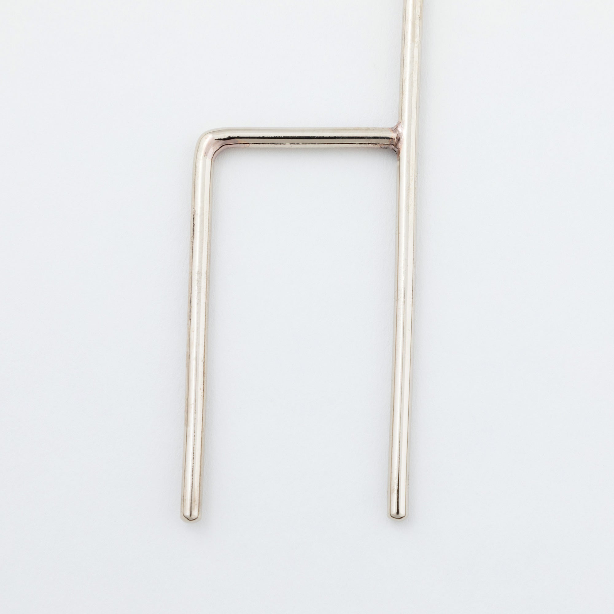 Close-up of the alpaca silver base prongs of the cactus plant stake, designed for easy and stable placement in soil.