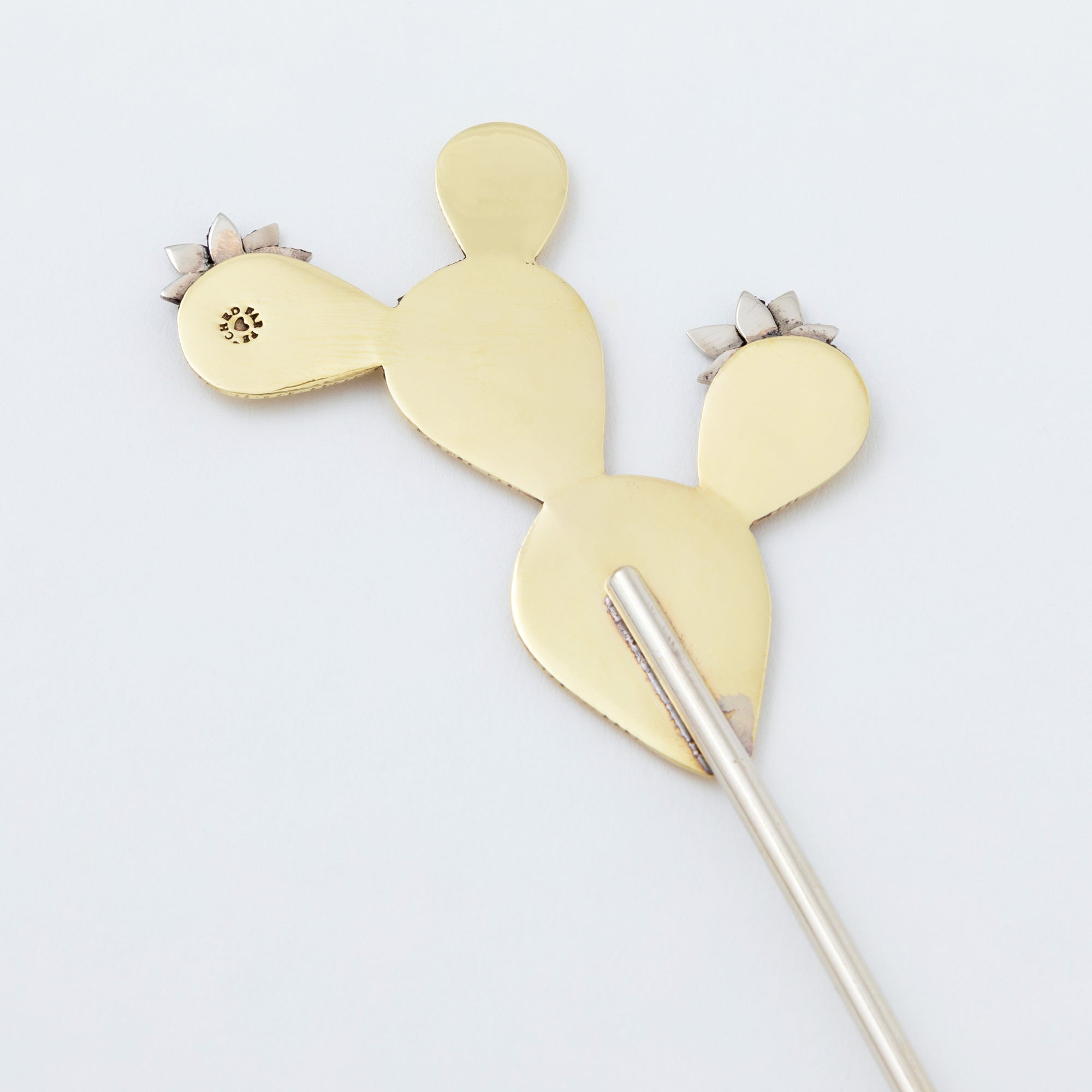 Back view of handmade cactus plant stake showing smooth brass surface and welded stem attachment. Crafted in Mexico by skilled artisans.