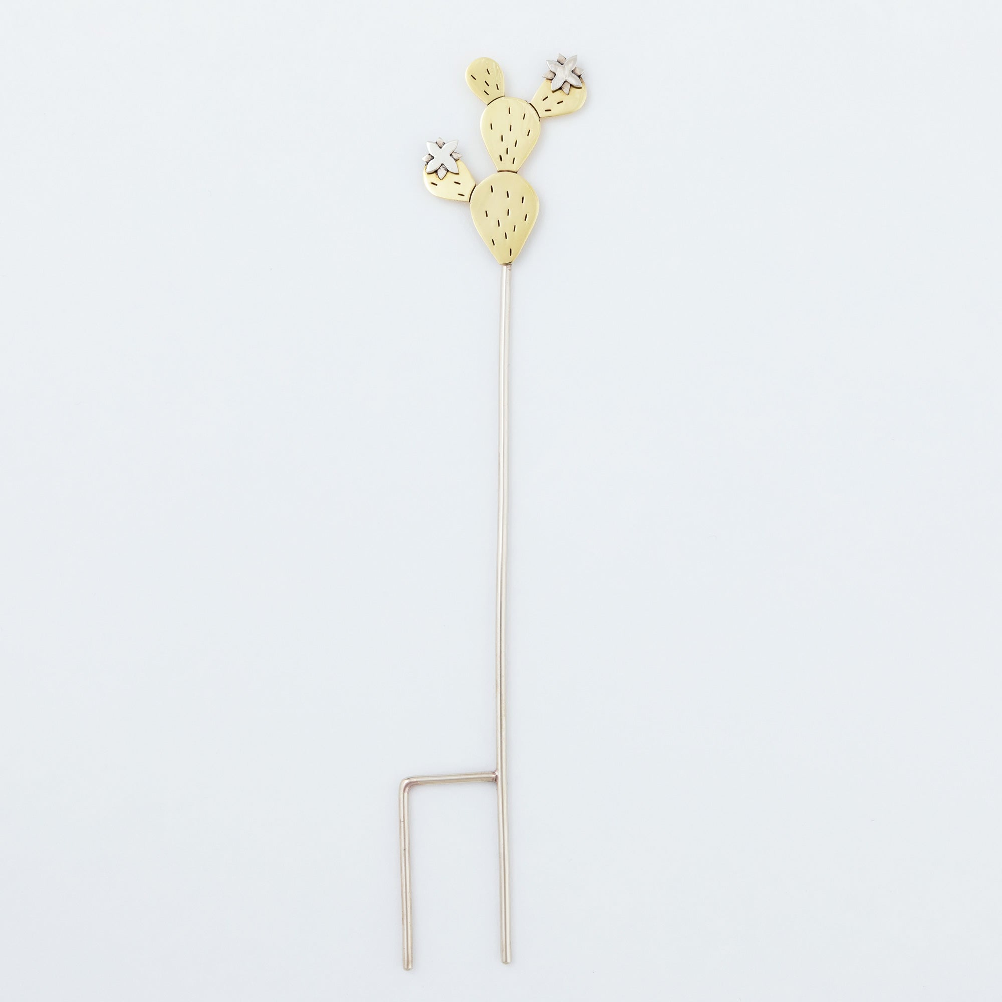 Full view of the cactus plant stake made from alpaca silver and brass, featuring a dual-prong base. Handmade by artisans in Cuervo, Mexico.