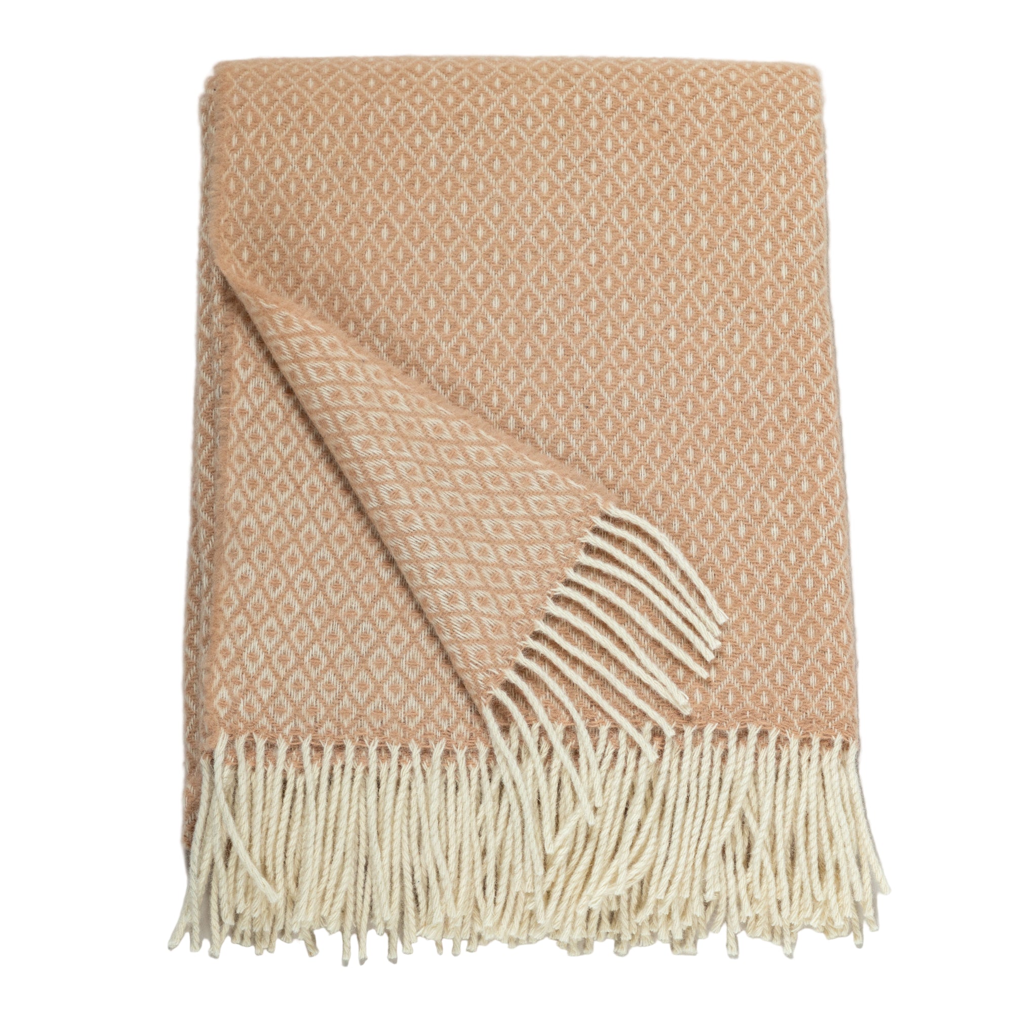 A peach-colored Ukrainian blanket with a small diamond weave pattern and cream fringe, neatly folded with one corner flipped over to show the reverse side of the fabric.