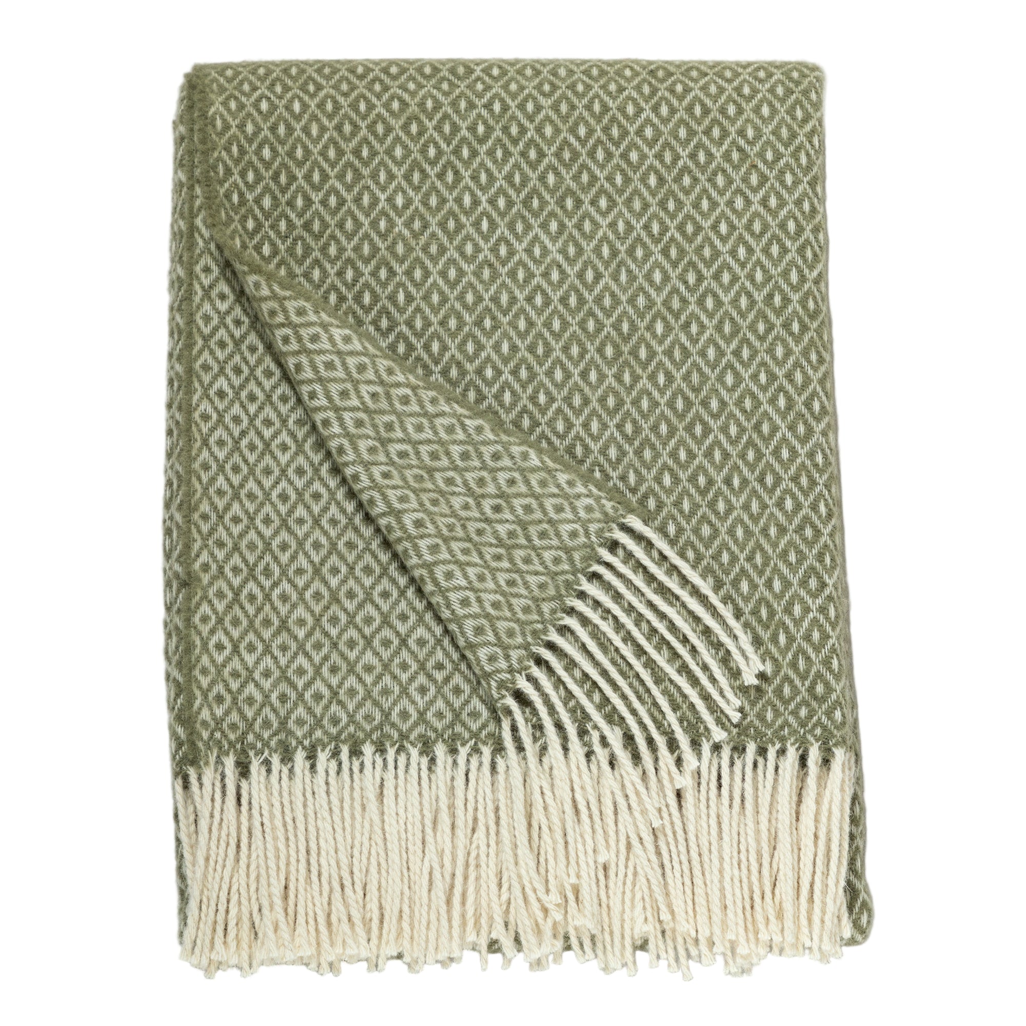 Detailed close-up of a folded green blanket with a diamond pattern and cream-colored fringe, showing texture and pattern clearly.