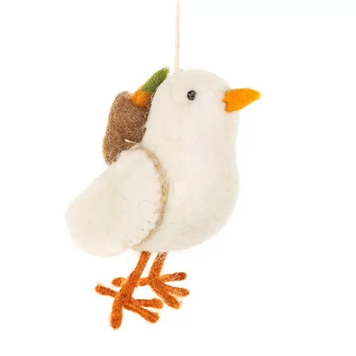 A handmade felt chick is shown, carrying a small pack with a carrot on its back.