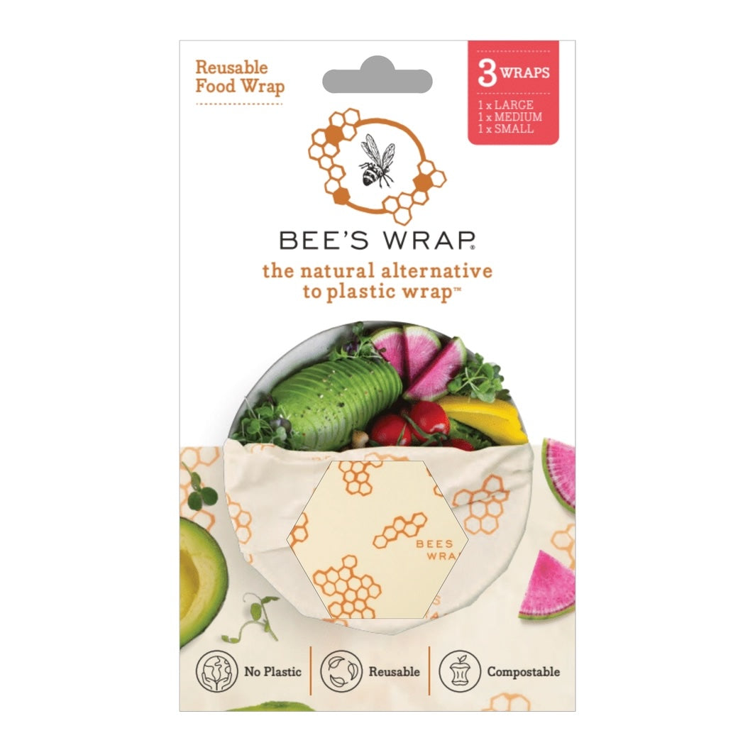 Packaging for Bee’s Wrap reusable food wraps showing a hexagonal window with a honeycomb-themed pattern and fresh vegetables inside the wrap.