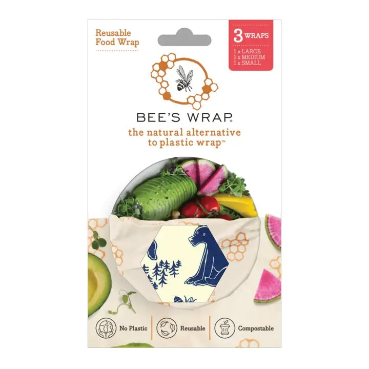 Packaging for Bee’s Wrap reusable food wraps showing a hexagonal window with a nature-themed pattern and fresh vegetables inside the wrap.