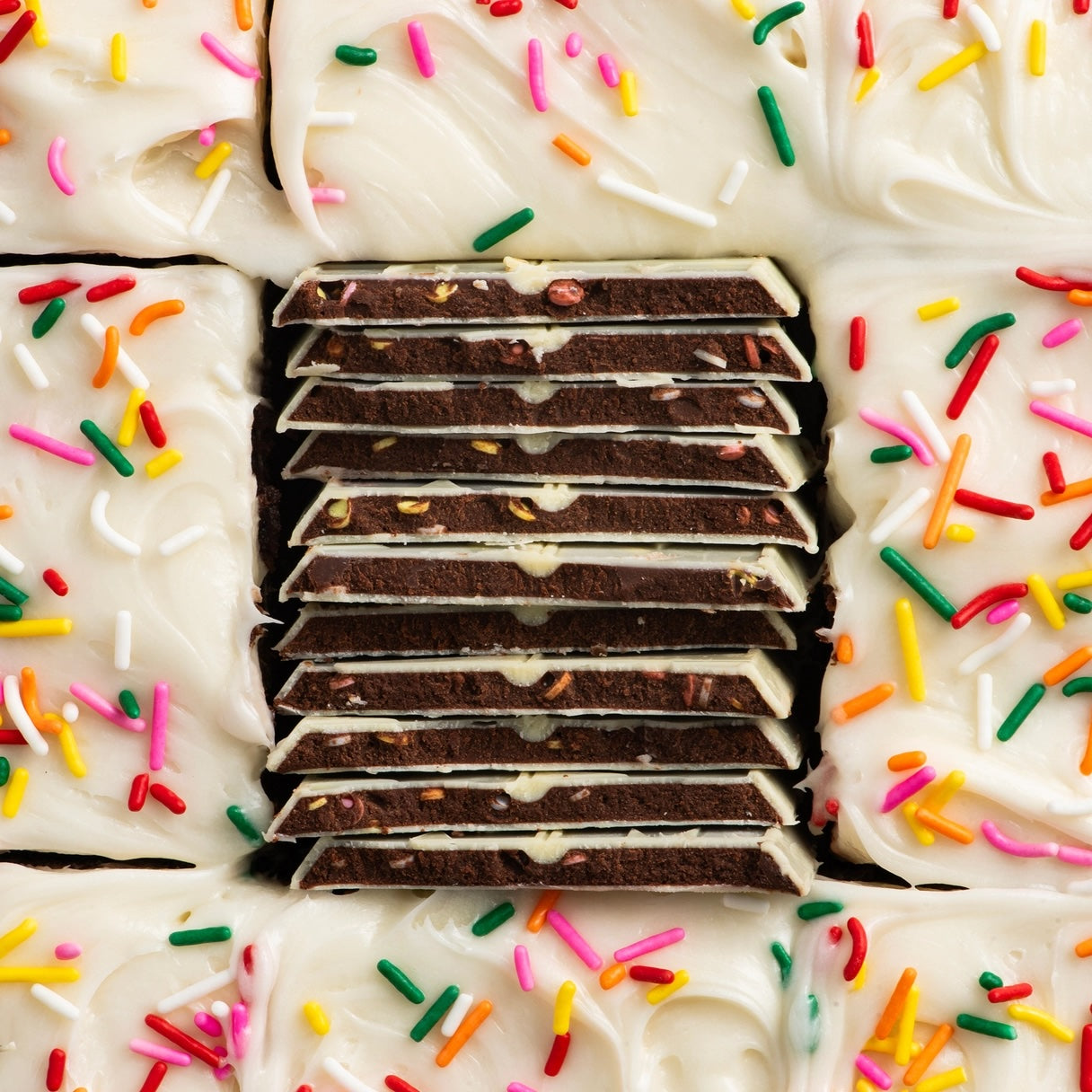 Maeve “Block Party Brownie” truffle bar displayed on a vibrant, multicolored background with festive sprinkles, evoking the playful and indulgent brownie flavor.
