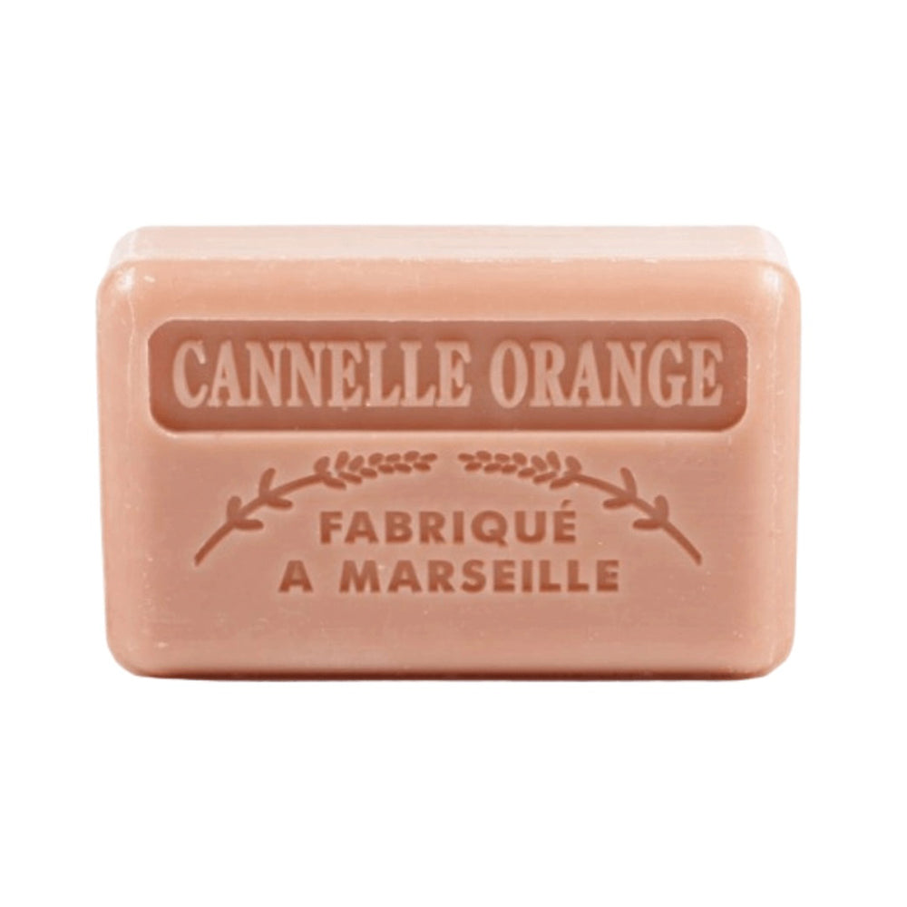 A brownish-pink soap bar with "Cannelle Orange" and "Fabriqué a Marseille" embossed on it on a white background.