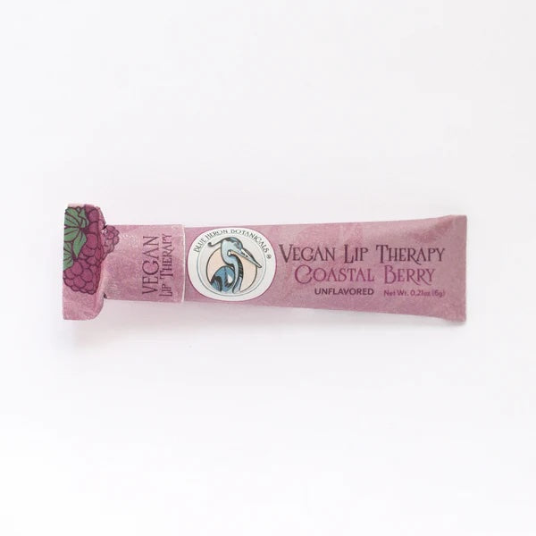 Coastal berry Lip Therapy Balm displayed upright, designed to hydrate and nourish lips using fair trade, ethically sourced ingredients.