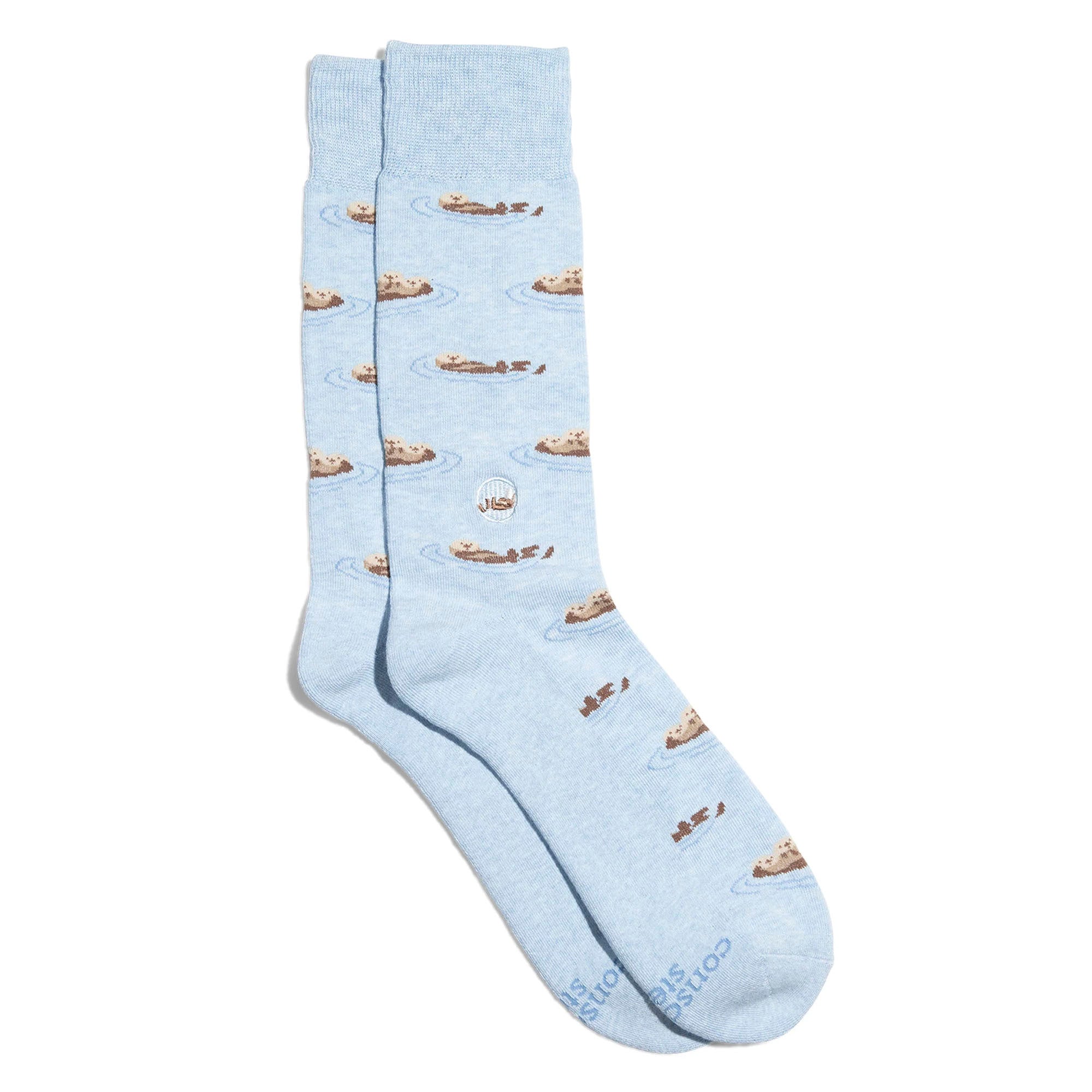 The image shows a pair of light blue socks with a pattern of sea otters floating on their backs, holding hands.