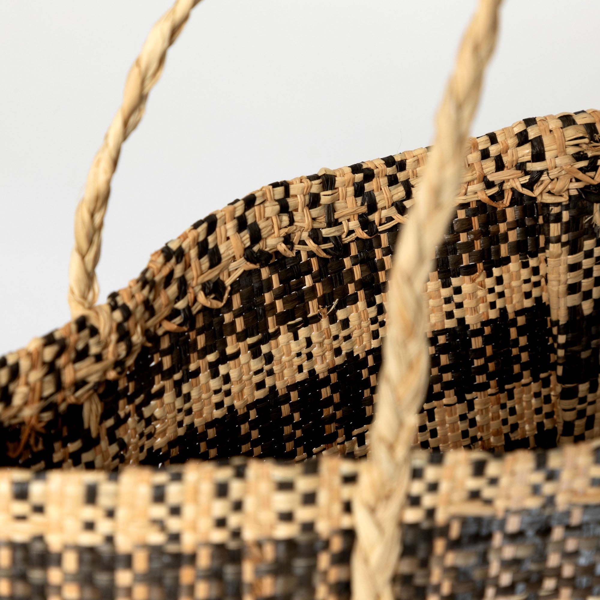 Close-up view of the handwoven African tote bag’s cotton-lined interior, featuring spacious compartments and braided handles. Handmade by artisans in the Democratic Republic of Congo using sustainable, vegetable-dyed grass fibers.