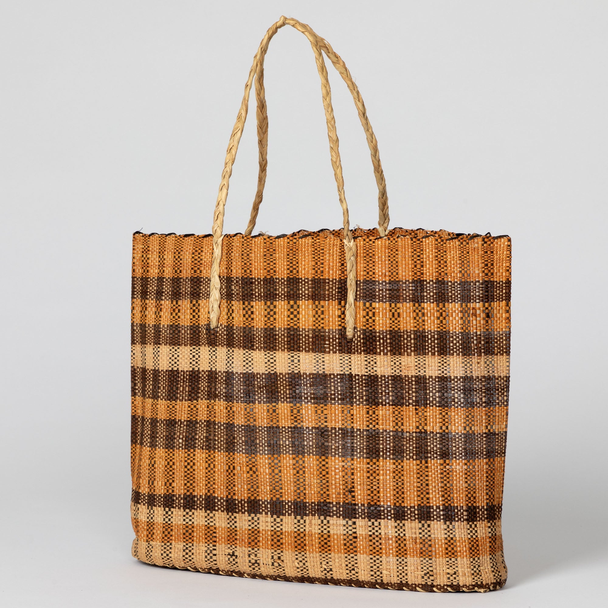 Image of the handwoven African tote bag, highlighting its natural texture and open design. Crafted by artisans supporting sustainable income in the Democratic Republic of Congo.