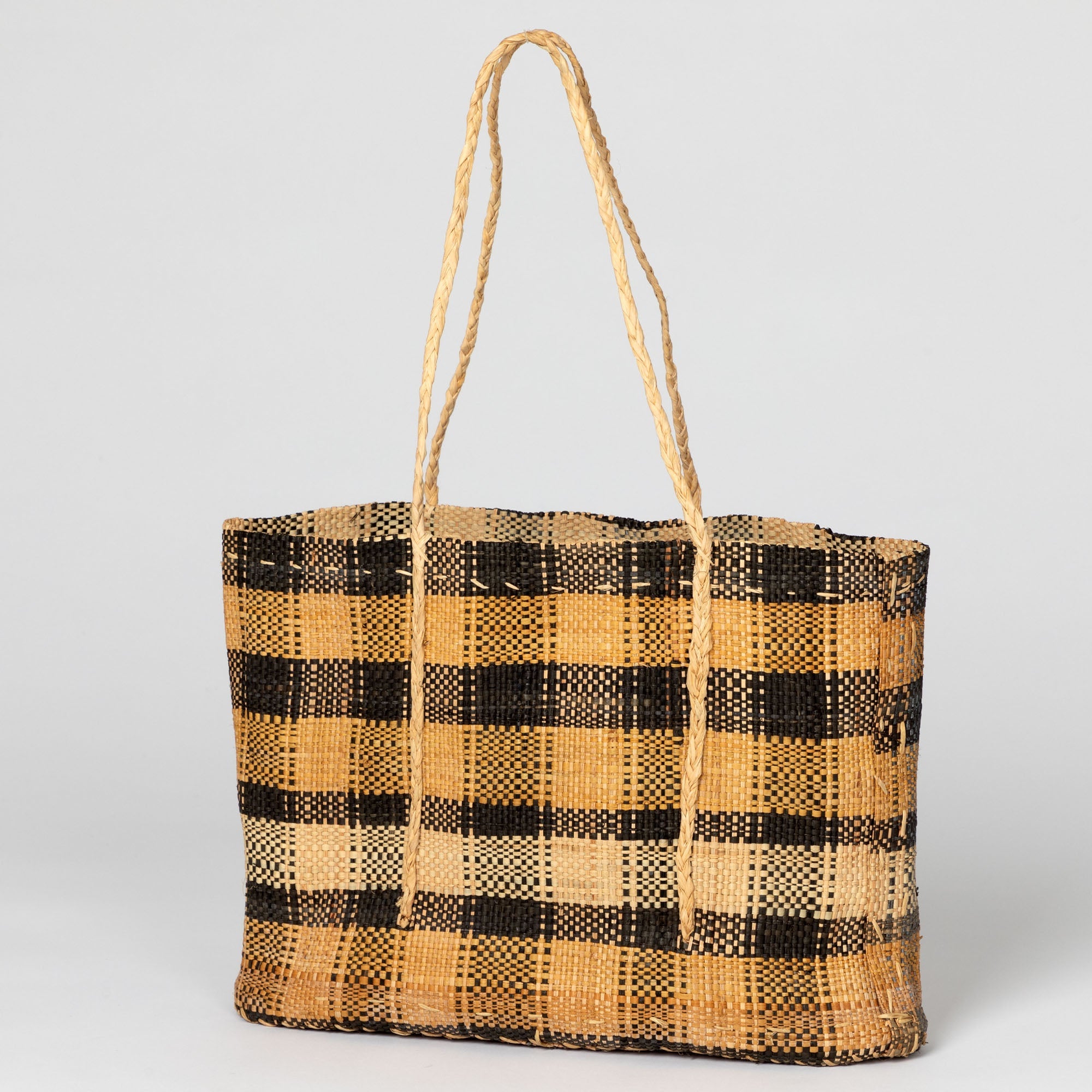 Handwoven African tote bag in rich brown shades, featuring an open, breathable design. Ethically crafted by artisans in the Democratic Republic of Congo.