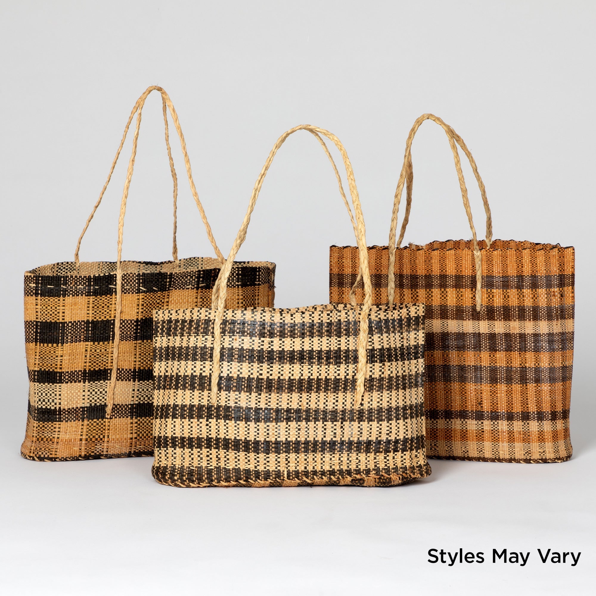 Set of three African tote bags made from vegetable-dyed grass fibers in natural earthy tones. Lightweight and durable, handcrafted by artisans supporting fair-trade in the Democratic Republic of Congo.