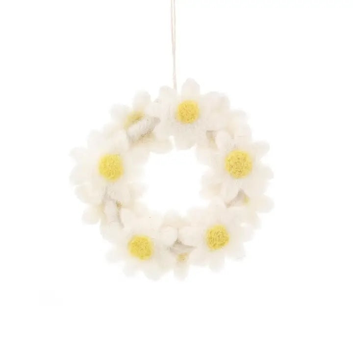 A handmade felt wreath is made of white daisies with yellow centers.