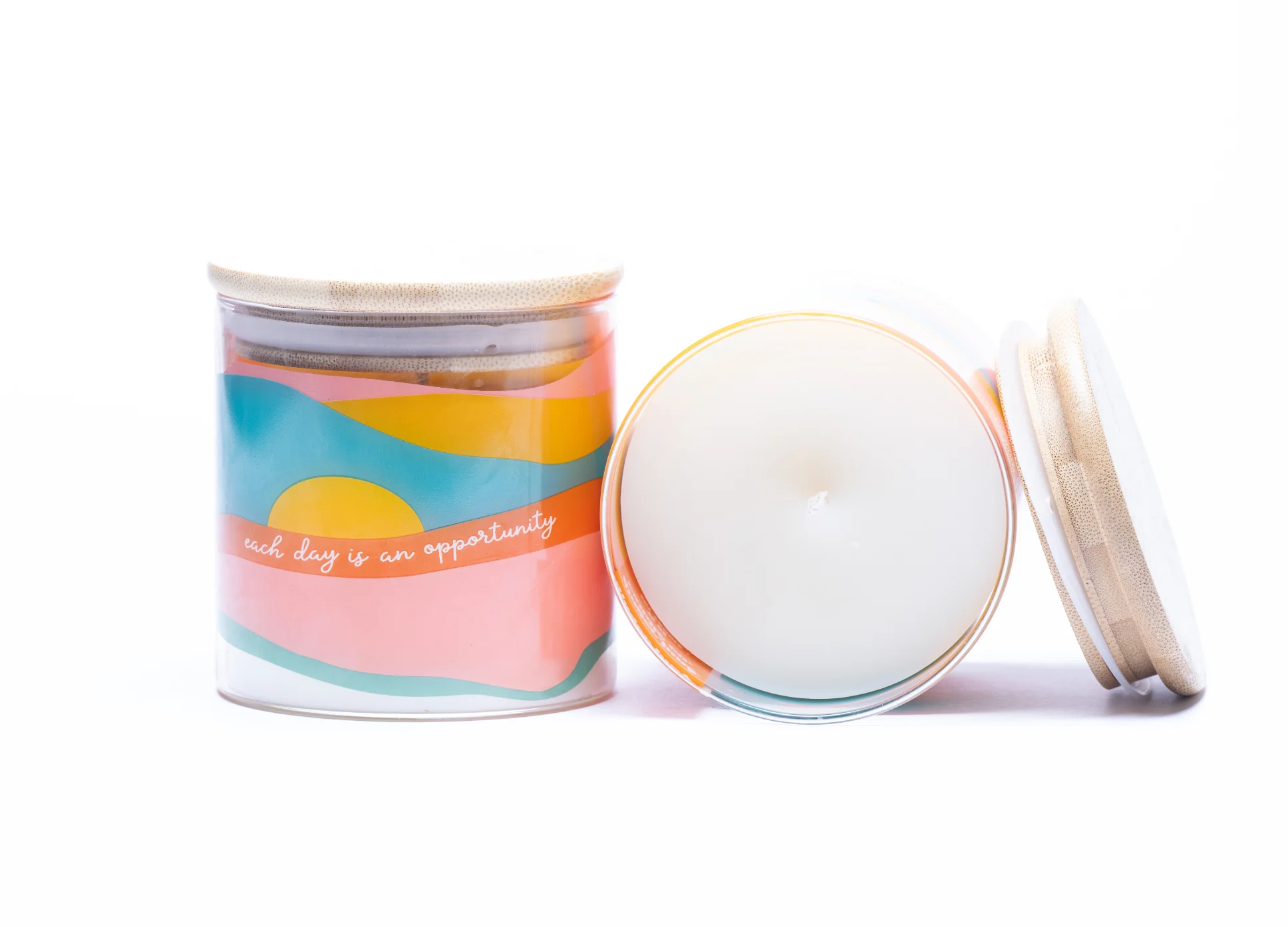 Essential oil blend candle in a clear glass tumbler labeled “Each Day Is an Opportunity.” Features a soy wax base and a bright, uplifting scent made with 100% essential oils.