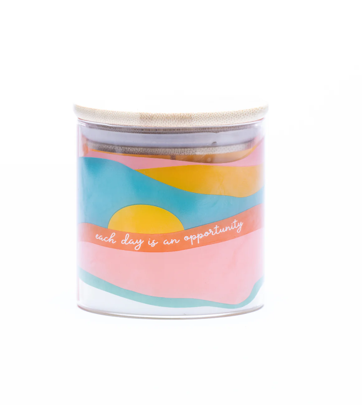 Hand-poured candle in a glass tumbler reading “Each Day Is an Opportunity,” made with soy wax and non-toxic essential oils.