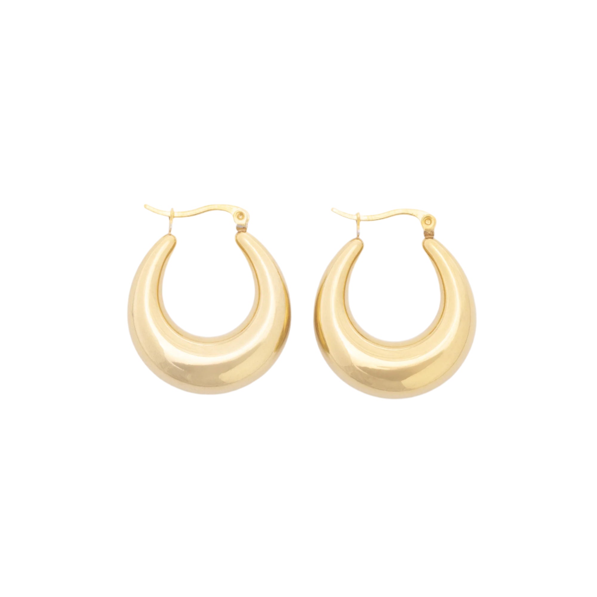 A pair of classic Gold Hoop earrings resting on a light surface, crafted from recycled stainless steel and finished in 14K gold for a clean, sustainable shine.