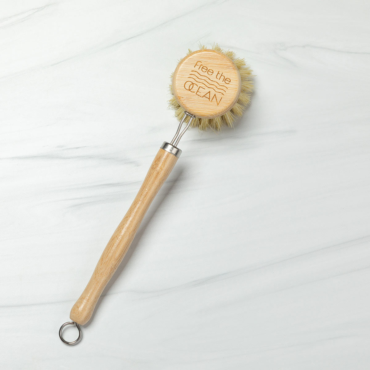 Dishwashing brush with wooden handle and bristles on a white background