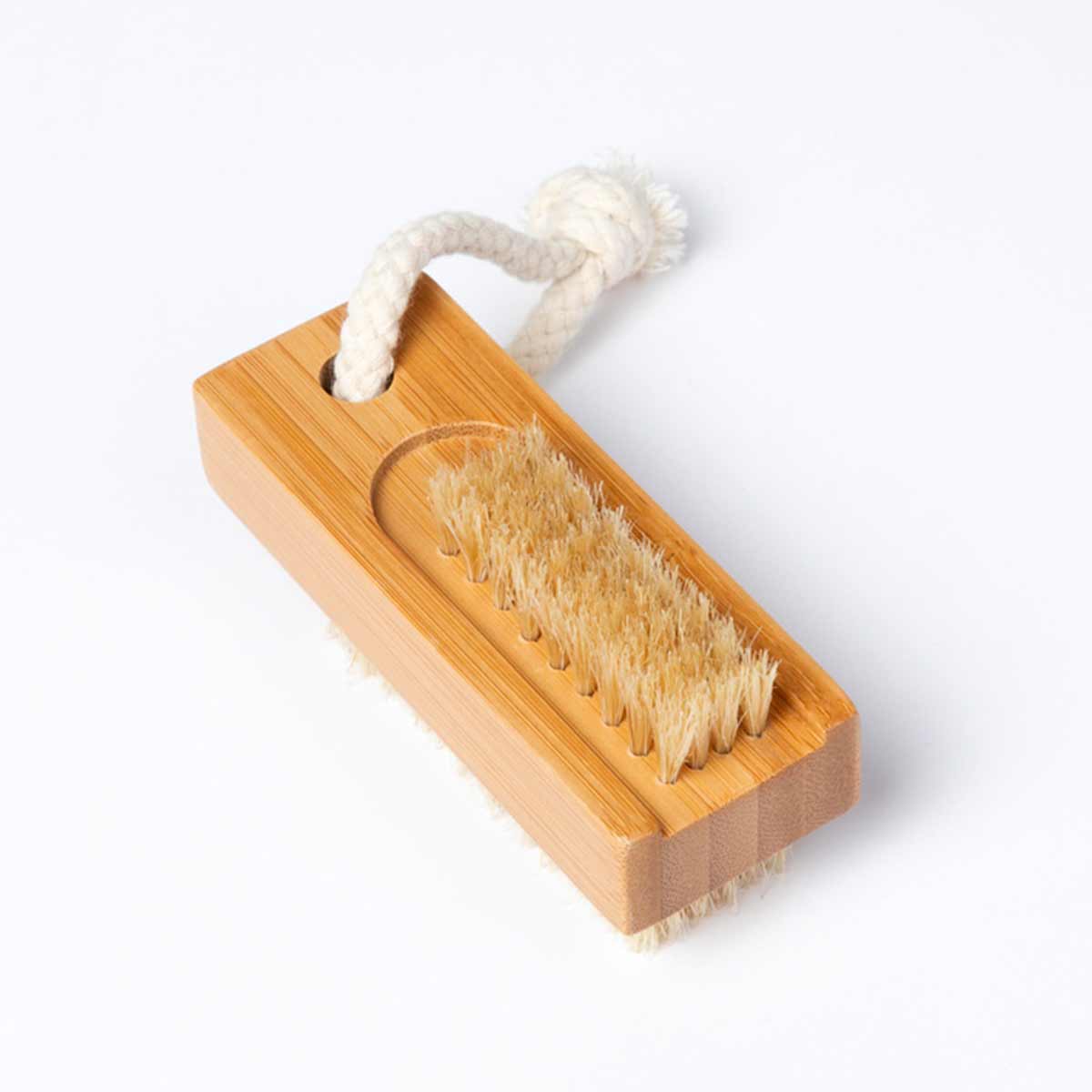 A bamboo nail brush with two sets of bristles and a braided rope loop is shown on a white surface.