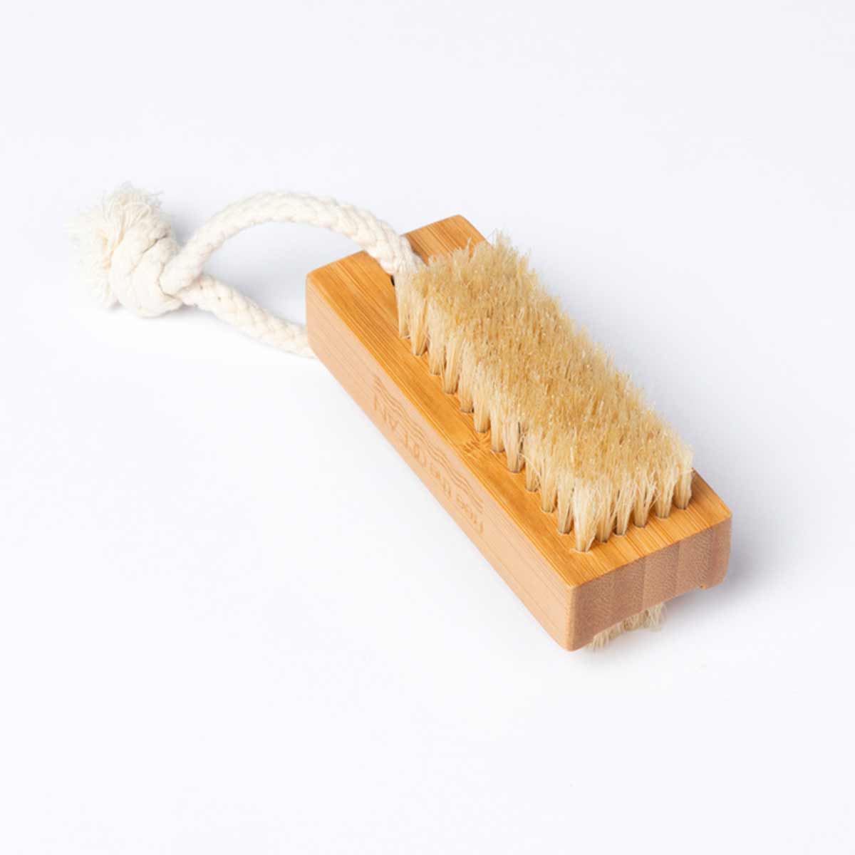 A bamboo nail brush with two sets of bristles and a braided rope loop is shown on a white surface.