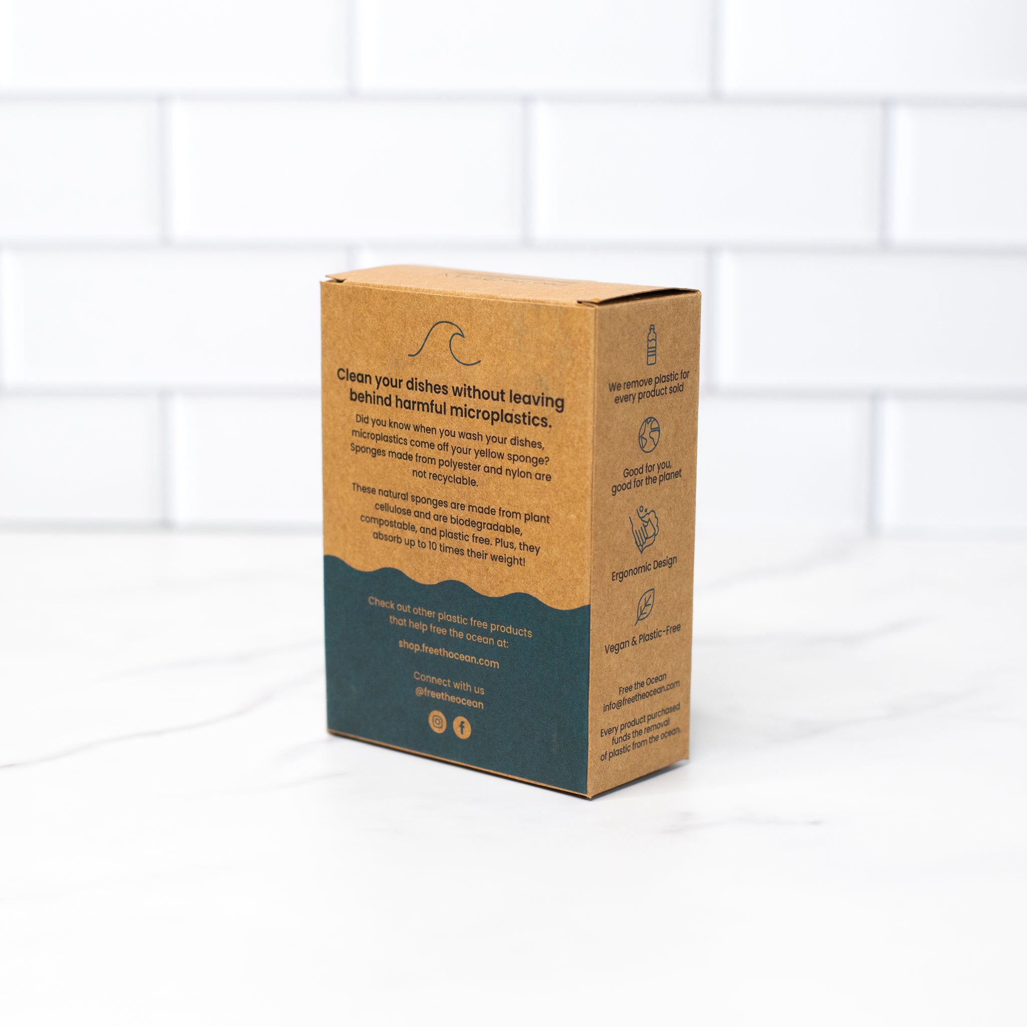 Angled rear view of the biodegradable kitchen sponges Kraft box, showing clear printing of product details and eco-friendly packaging claims.