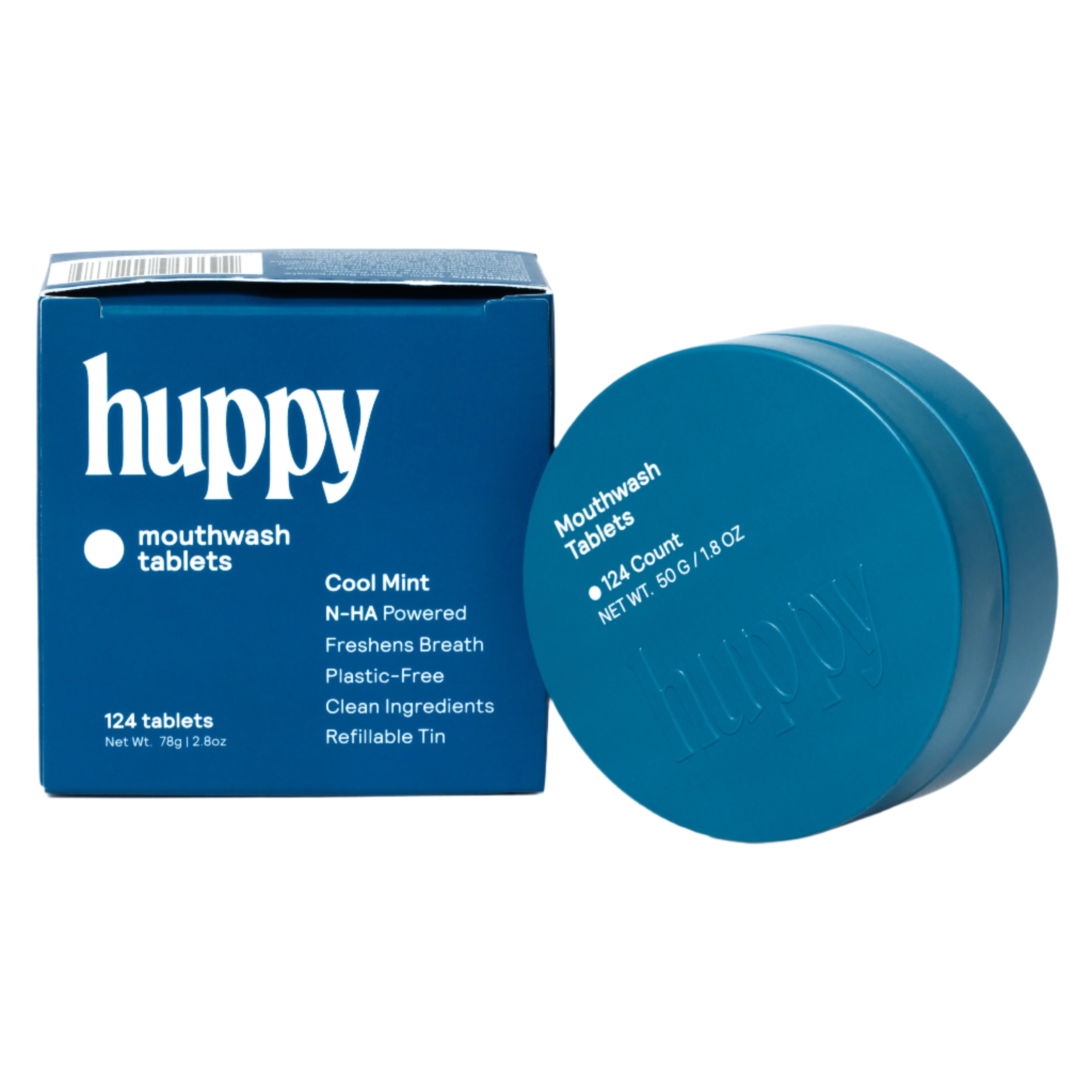 A cute Huppy mouthwash set is shown with a closed blue tin next to its refill box. The box highlights that it contains "124 tablets" of "Cool Mint" and is a "Refillable Tin", providing a new view of the packaging and product together.