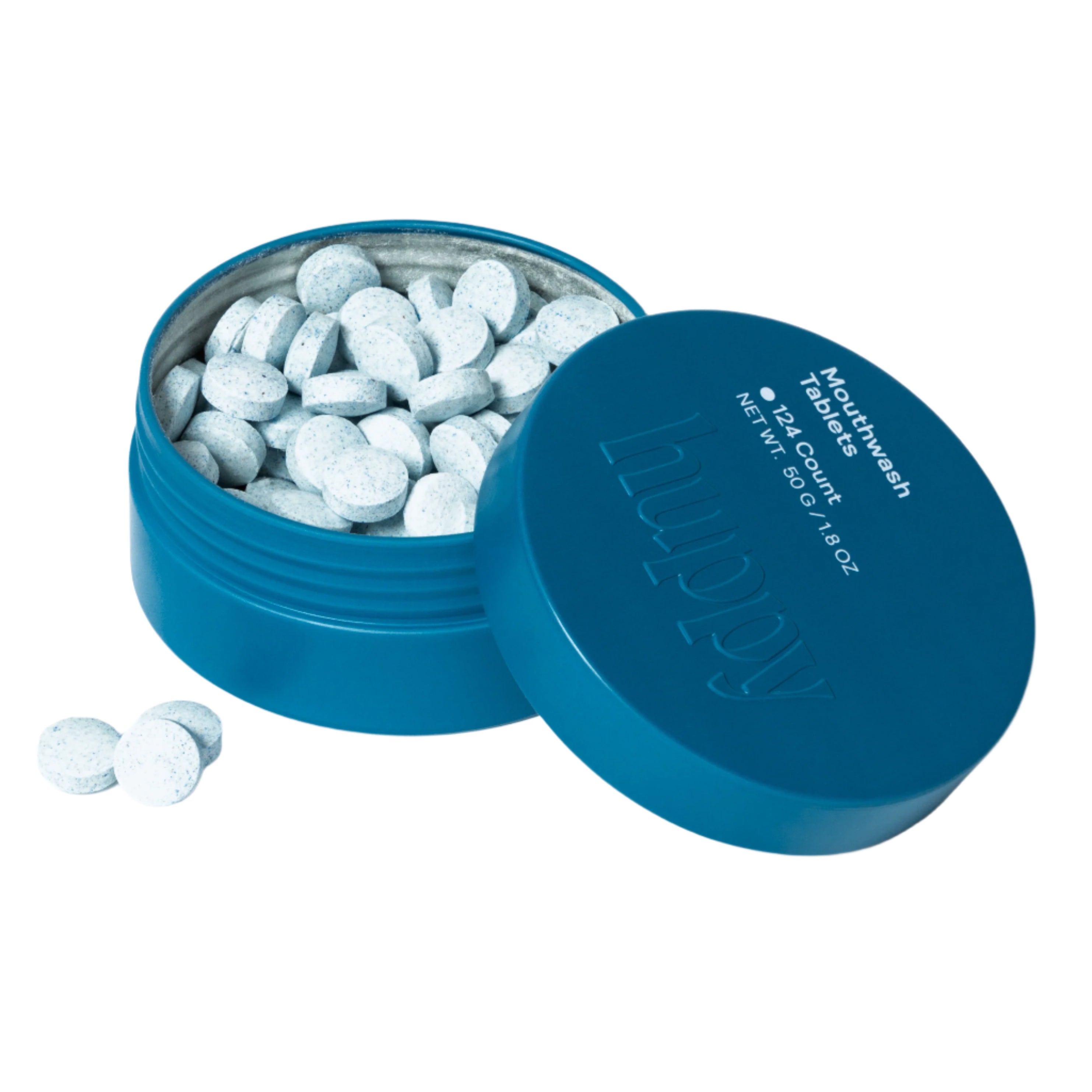 A cute overhead shot of a blue Huppy mouthwash tin, open to reveal many white tablets inside. The lid is placed next to it with a few tablets scattered nearby.