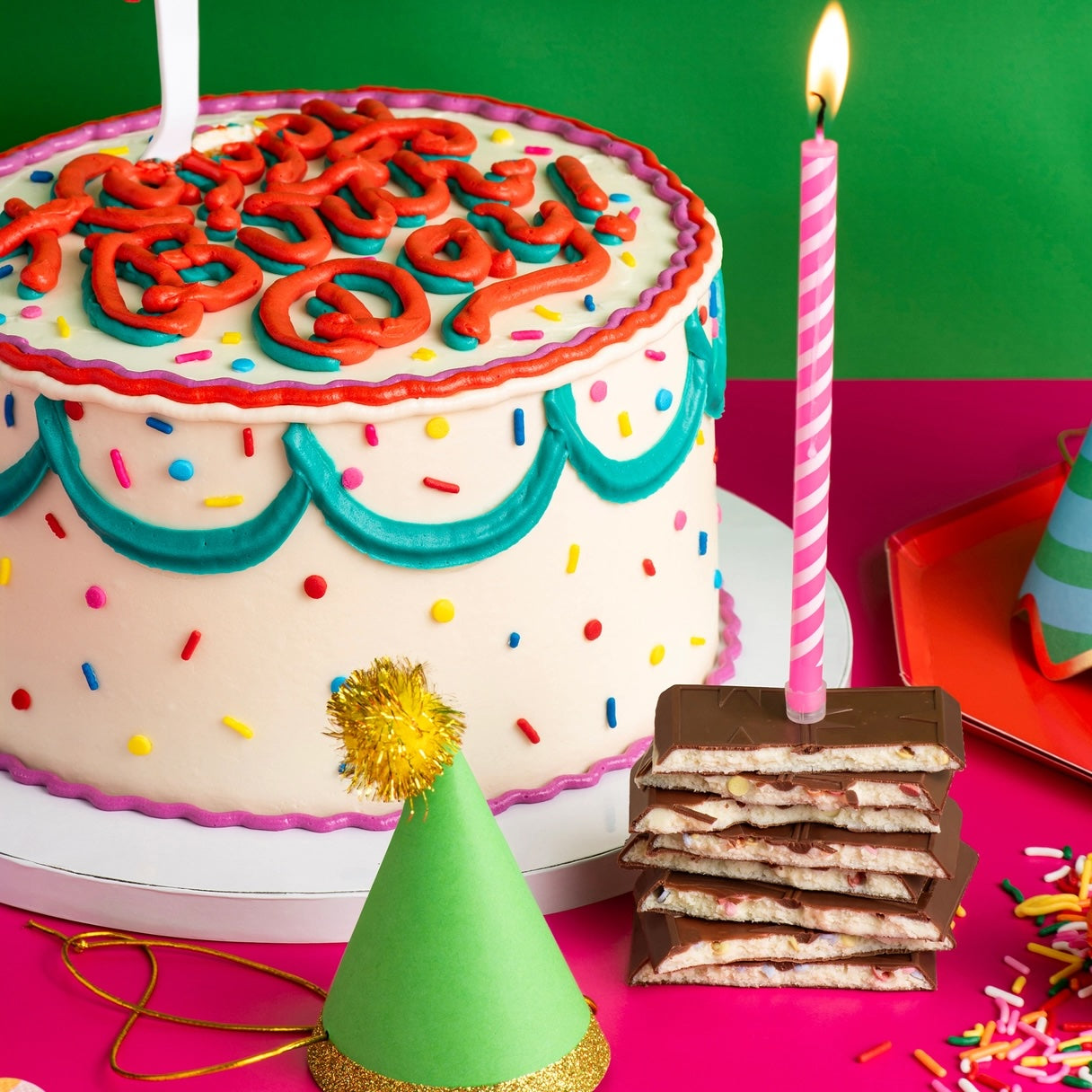 A colorful layered birthday cake decorated with sprinkles and bright frosting, celebrating special moments—paired with the Maeve “Happy Birthday” chocolate bar collection that’s fair-trade, non-GMO, and ethically crafted.