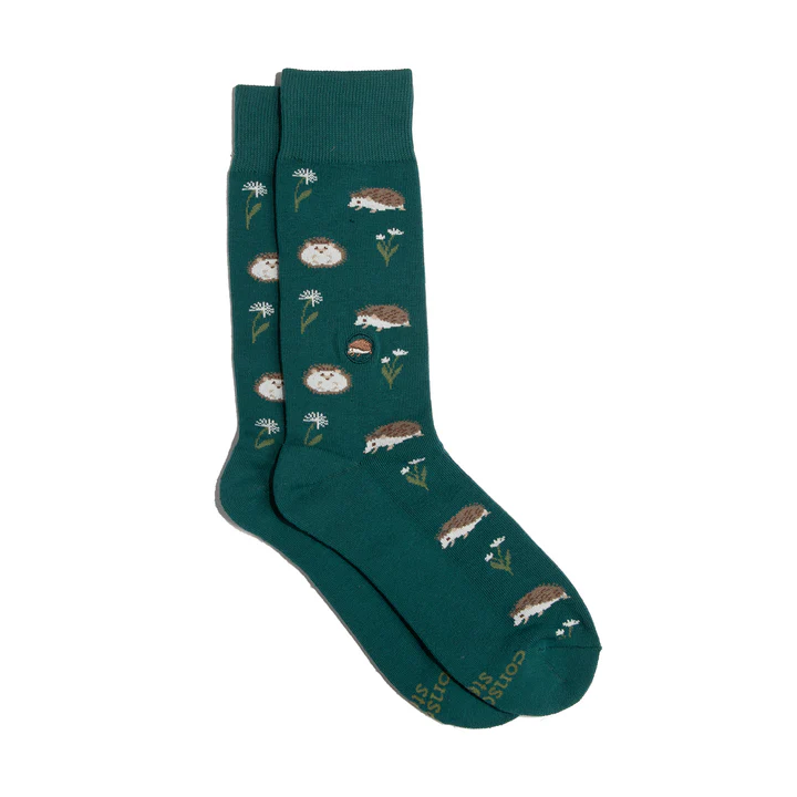 A pair of green socks with a pattern of red and white porcupines is shown against a white background. The brand name is visible on the bottom of the socks.