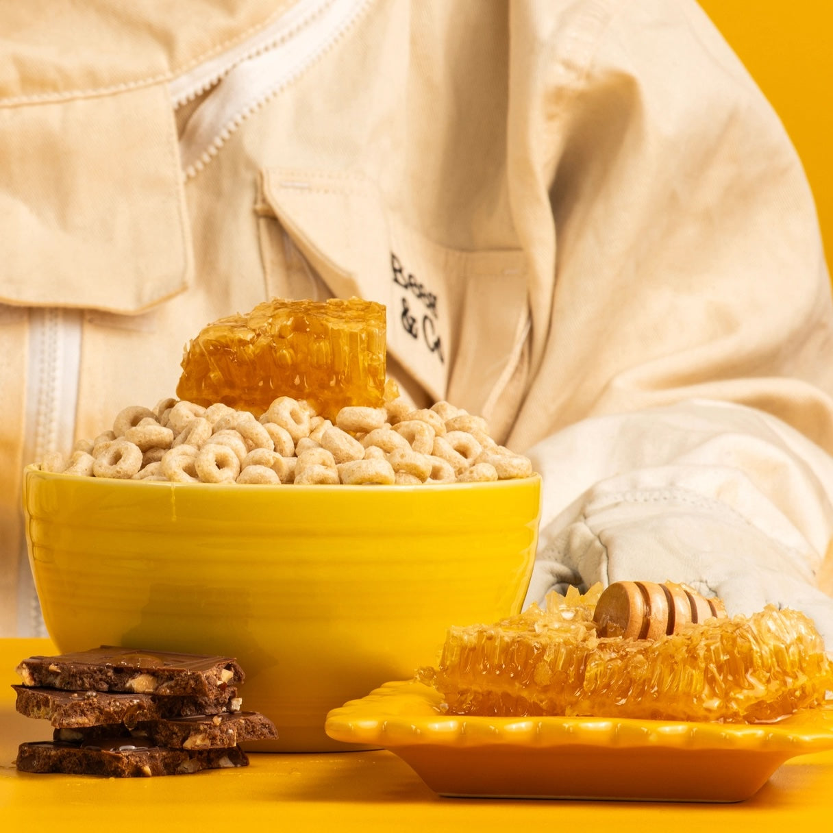 A close-up of a bowl filled with crunchy Honey Nutty Ohs cereal, showcasing golden toasted oats and nuts with a splash of milk, perfect for a wholesome breakfast.