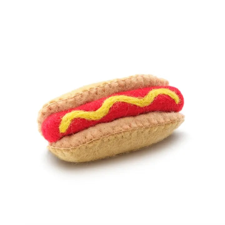 A wool hot dog cat toy with a bun and mustard detail, handmade and filled with catnip for playful chewing.
