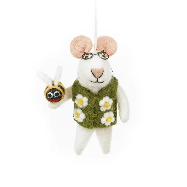 A handmade felt mouse is shown, wearing an olive green vest with white daisy flowers on it. The mouse is also wearing glasses and is holding a small felt bee.