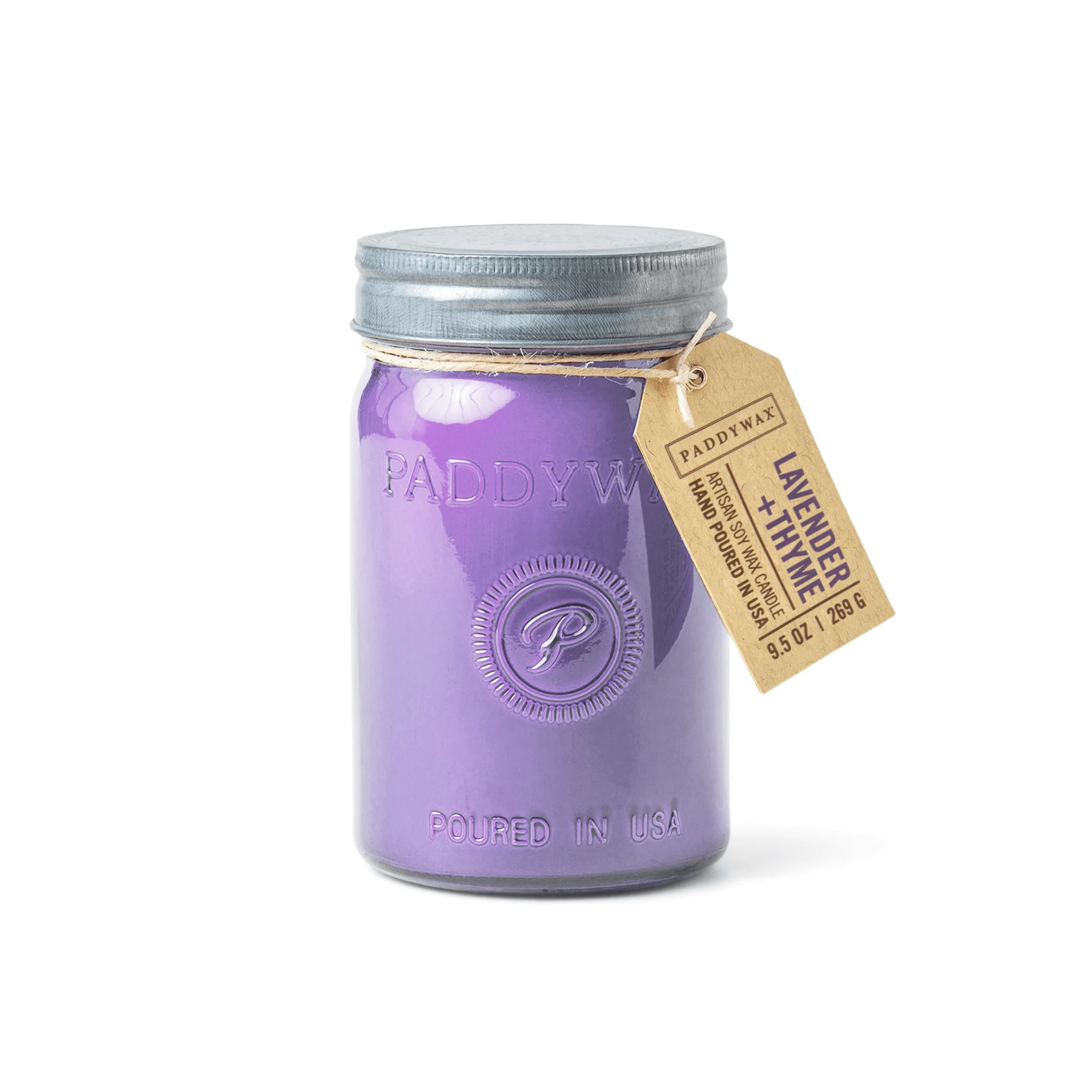 A purple Paddywax artisan soy wax candle is shown in a jar with a metal lid and a tag. The tag identifies it as "Lavender + Thyme" and notes it's hand-poured in the USA.