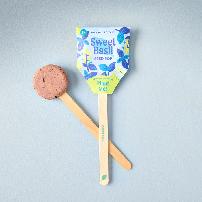 A sweet basil seed pop on its bamboo stick, shown next to its round brown planting pod. The colorful package illustrates the fun and easy process of growing fresh basil.
