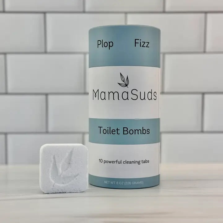 A resealable kraft pouch of MamaSuds Toilet Bombs placed on a marble surface.