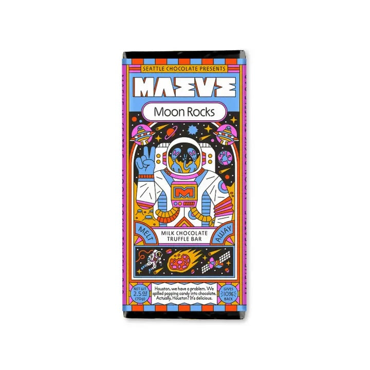 Maeve “Moon Rocks” truffle bar in a dark blue space-themed setting with glowing star accents, evoking its cosmic flavor and playful packaging.