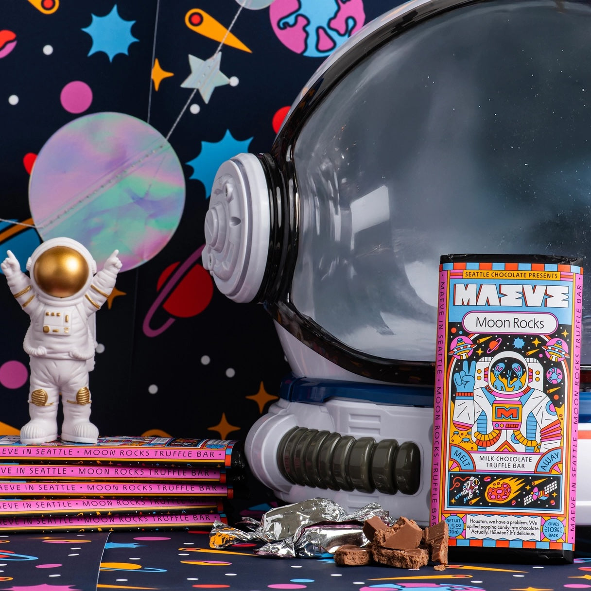 Maeve “Moon Rocks” chocolate bar displayed against a galactic backdrop, highlighting its otherworldly theme and bold, imaginative branding.