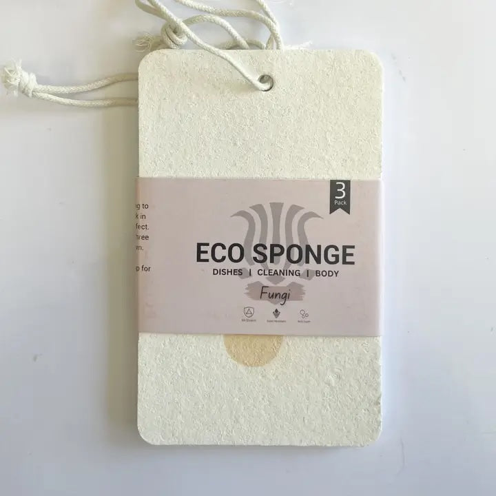 Pack of three compostable eco sponges with the label facing forward, biodegradable and made without plastics or bioplastics.