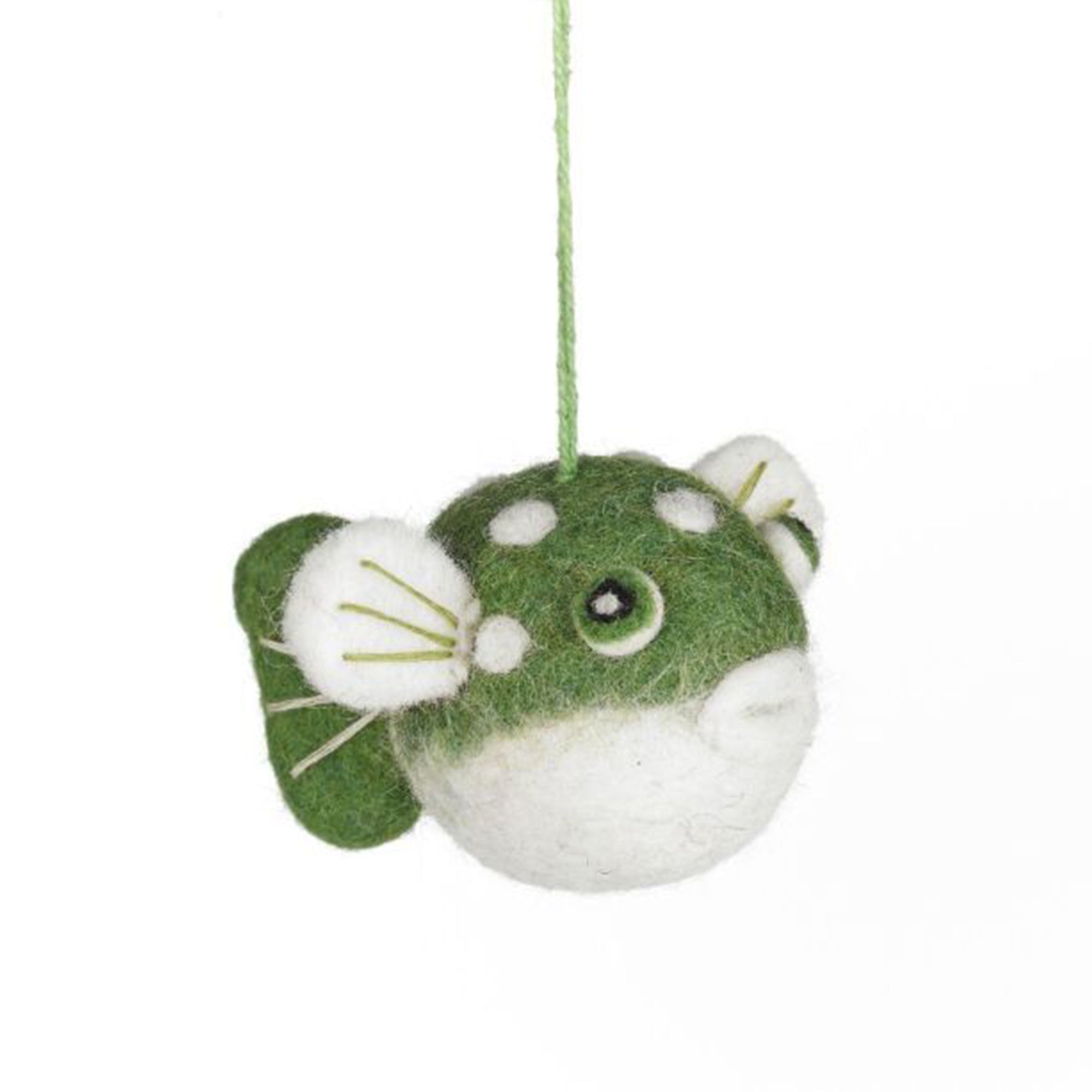 Green and white puffe fish felt ornament hanging on a string against a white background