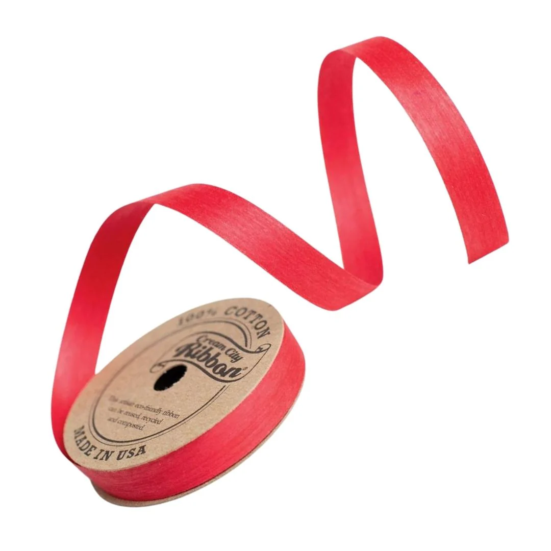 Close-up of vibrant red natural cotton curling ribbon showing its soft texture and eco-friendly water-based dye. Made from 100% cotton yarn and compostable.