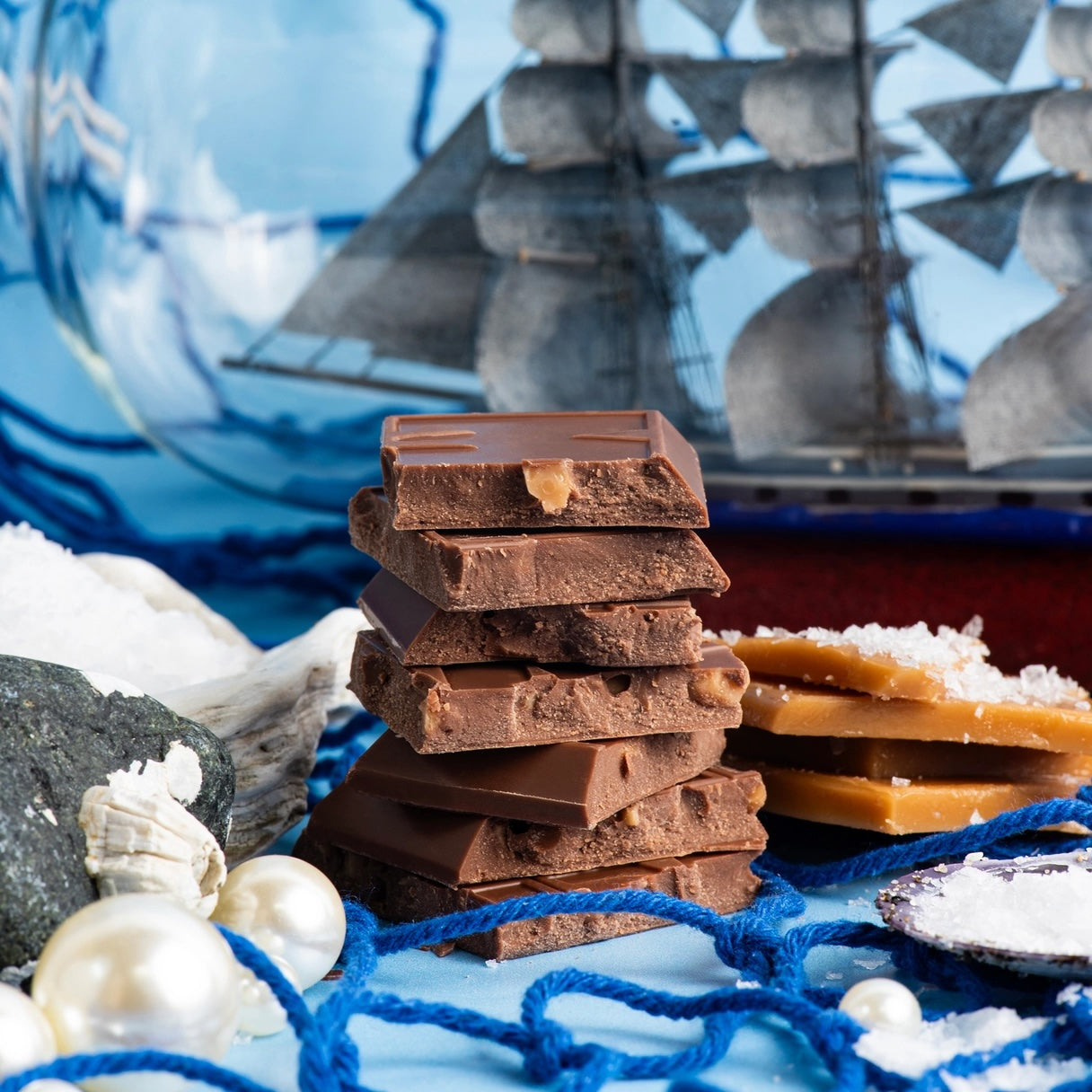 Close-up of “San Juan Salted Toffee” Maeve chocolate pieces on a boat background.