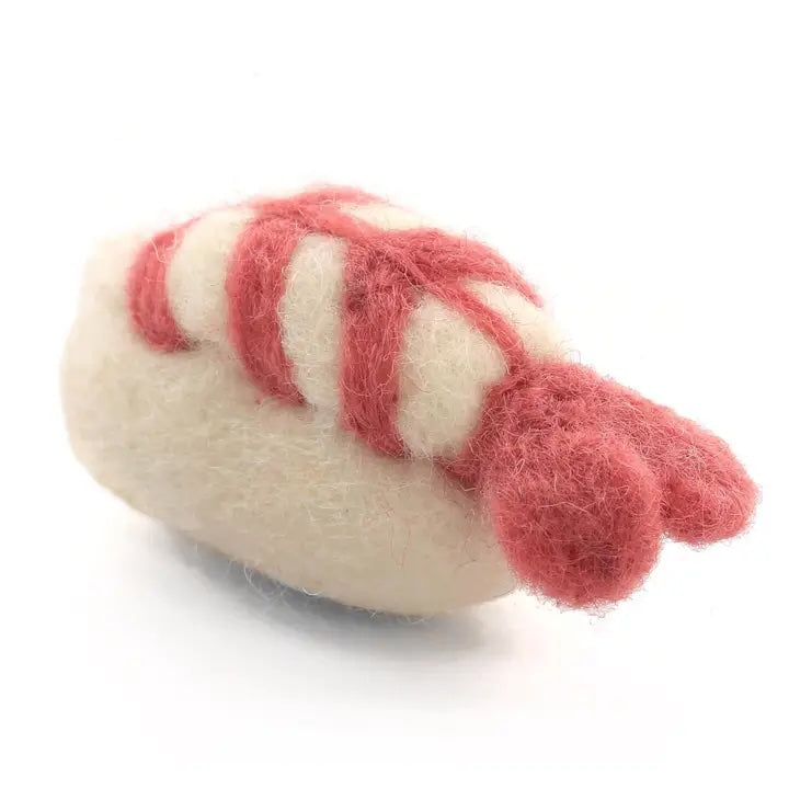 A felted wool sushi roll cat toy in white, green, and orange, Fair Trade crafted with natural materials.