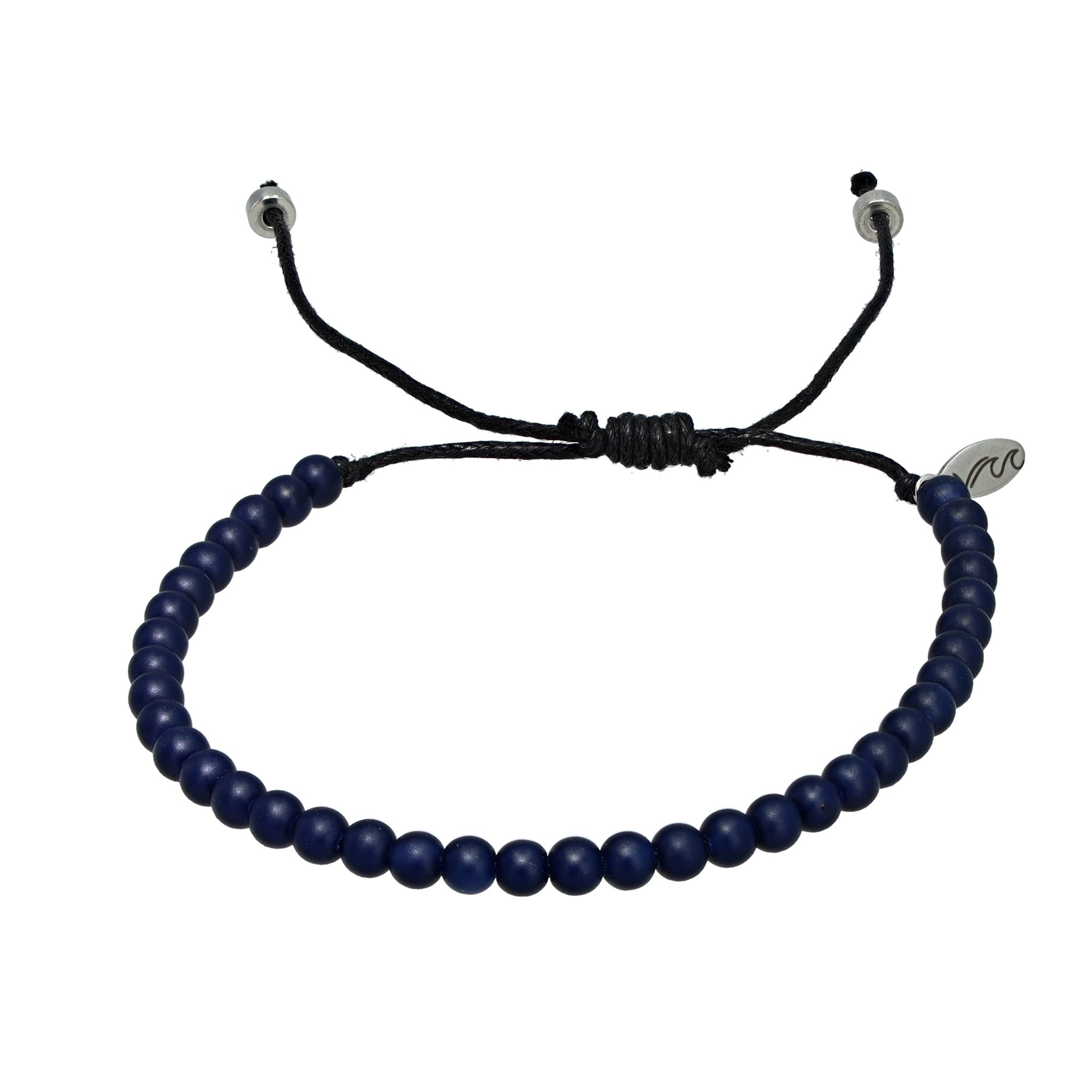 Dark blue recycled ocean plastic bracelet with a silver charm and adjustable design. Ethically handcrafted in Bali to help remove waste from waterways.